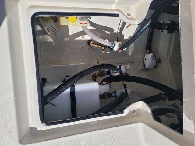 Slide: The Image of 2023 Pathfinder 2400 Open boat compartment with hoses and fittings. - 22