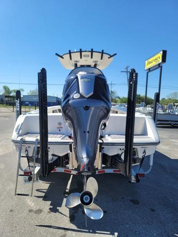 Slide: The Image of 2023 Pathfinder 2400 Open boat with powerful outboard motor, parked outdoors. - 24