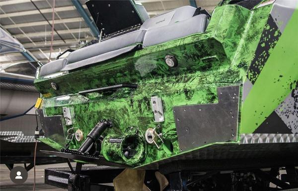 Slide: The Image of 2018 Pavati AL26 boat with green and black custom paint in a workshop. - 1