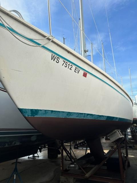 Slide: The Image of 1978 Pearson 26 sailboat on dry dock, hull view with registration number WS 7512 EV. - 1