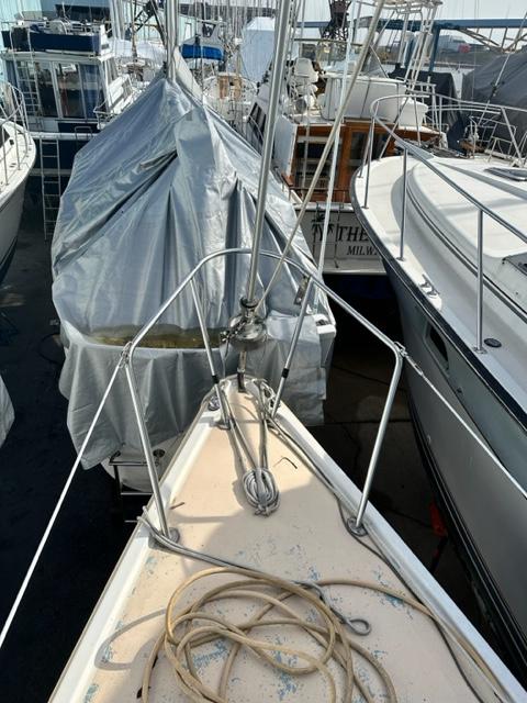 Slide: The Image of 1978 Pearson 26 sailboat bow view in marina, surrounded by other boats. - 10