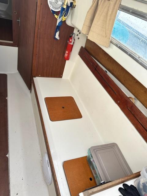 Slide: The Image of Interior of a 1978 Pearson 26 sailboat with wooden accents and storage compartments. - 15