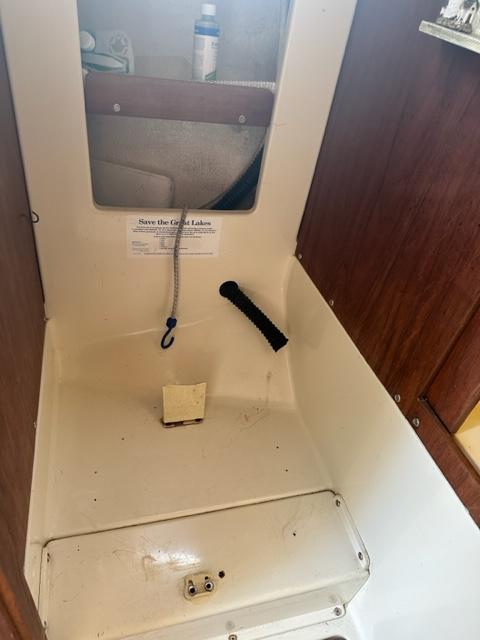 Slide: The Image of Interior of a 1978 Pearson 26 sailboat showing a storage compartment. - 16