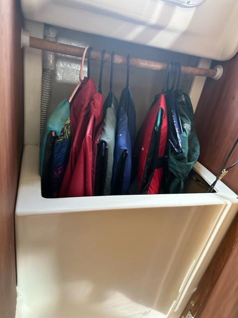 Slide: The Image of Life jackets hanging in a 1978 Pearson 26 sailboat storage compartment. - 17
