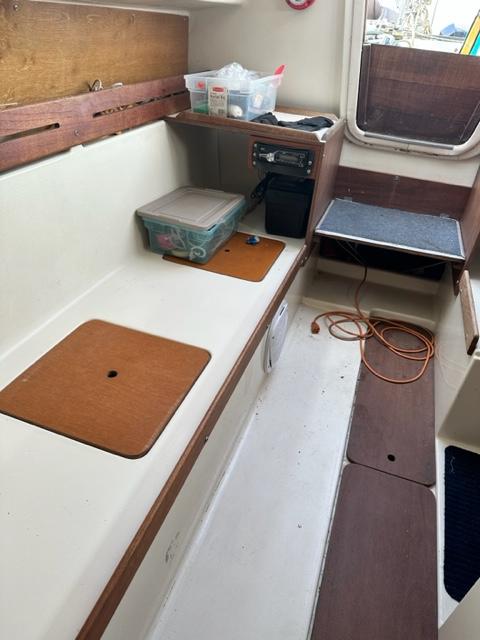 Slide: The Image of Interior of a 1978 Pearson 26 sailboat with storage compartments and electrical equipment. - 18