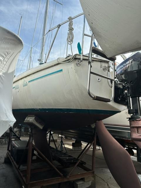 Slide: The Image of 1978 Pearson 26 sailboat on a stand in a boatyard. - 5