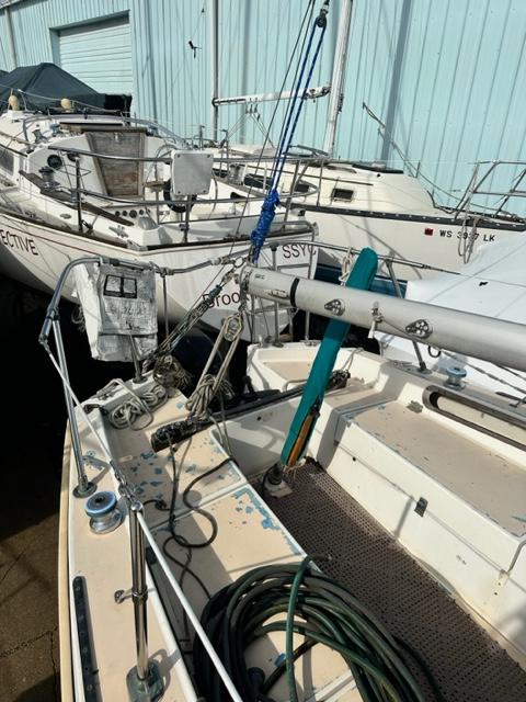Slide: The Image of 1978 Pearson 26 sailboat in a marina, surrounded by other boats. - 8