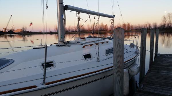 Slide: The Image of 1989 Pearson 31 sailboat docked at sunset. - 1