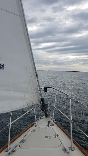 Slide: The Image of Sailing on a 1989 Pearson 31 yacht under cloudy skies. - 11