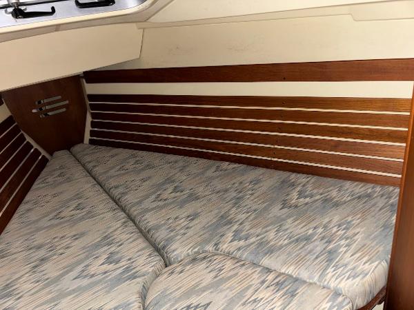 Slide: The Image of Interior cabin of 1989 Pearson 31 sailboat with cushioned V-berth and wooden paneling. - 18