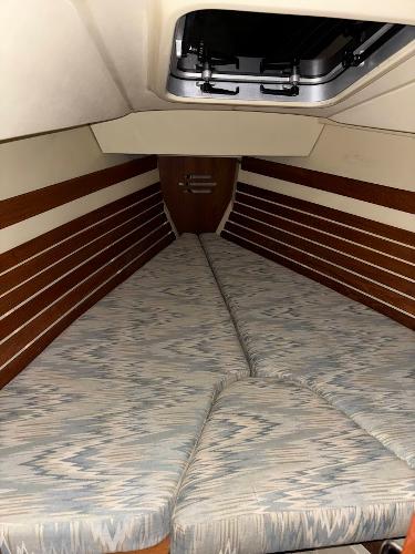 Slide: The Image of V-berth cabin interior of 1989 Pearson 31 sailboat with patterned cushions. - 19