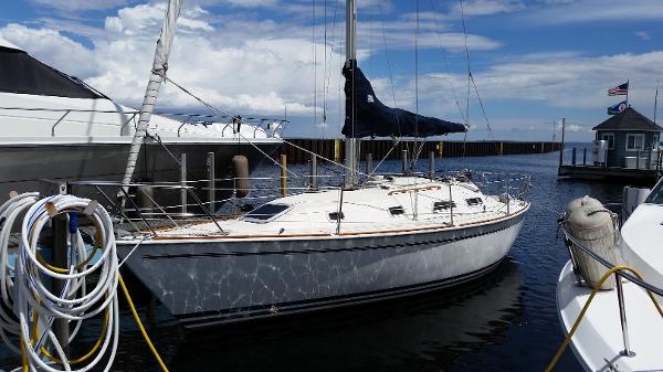 Slide: The Image of 1989 Pearson 31 sailboat docked at a marina on a sunny day. - 2