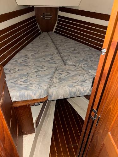 Slide: The Image of Cabin interior of 1989 Pearson 31 sailboat with V-berth and wooden paneling. - 20