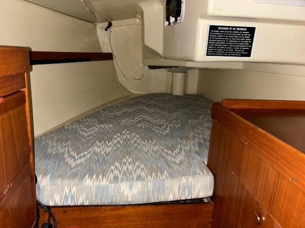 Slide: The Image of Interior cabin of 1989 Pearson 31 sailboat with cushioned sleeping area. - 28