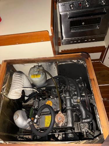 Slide: The Image of Engine compartment of a 1989 Pearson 31 sailboat with adjacent kitchen stove. - 31