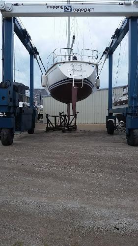 Slide: The Image of Pearson 31 sailboat from 1989 being lifted by a Marine Travelift. - 6