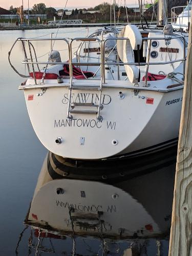 Slide: The Image of Pearson 31 sailboat docked, named Seawind, from Manitowoc, WI, reflecting on calm water. - 9
