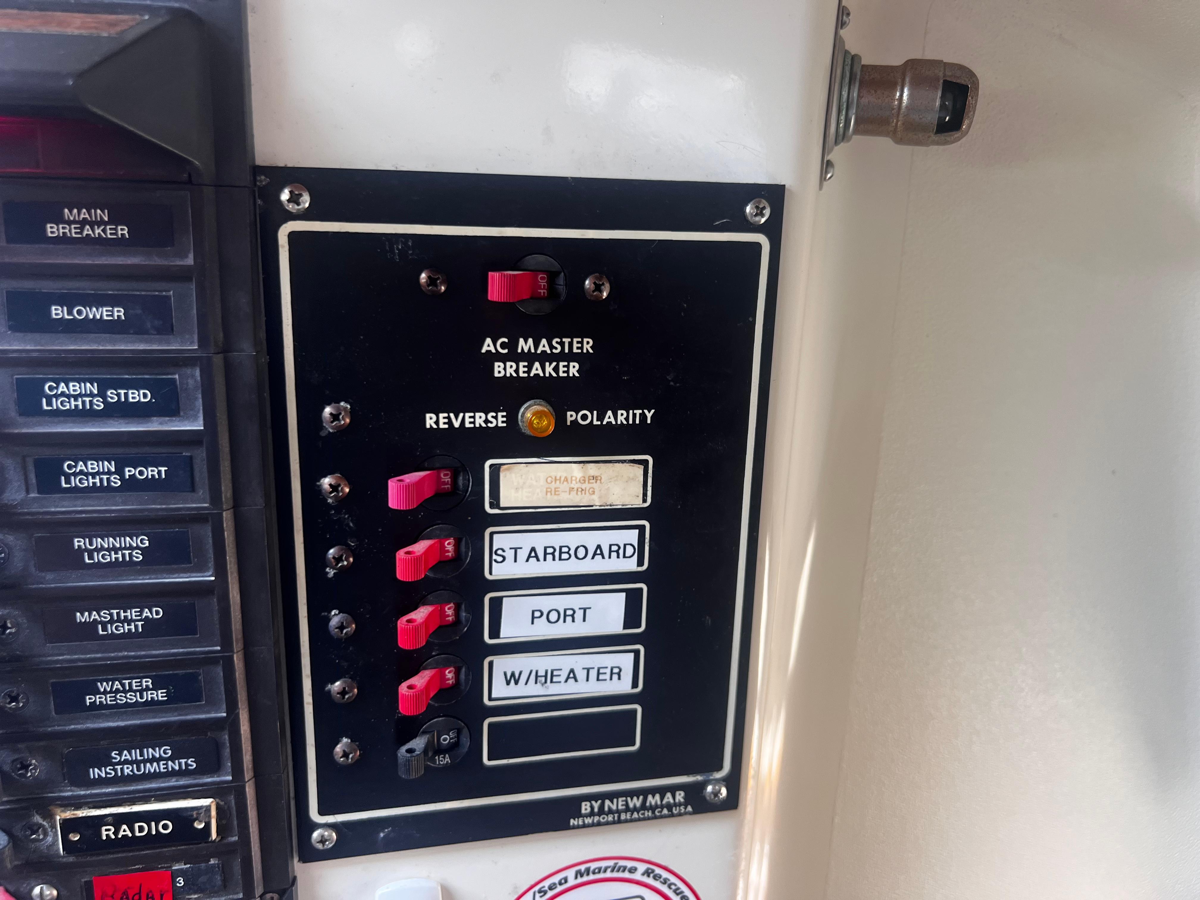 Slide: The Image of Electrical panel on a 1980 Pearson 32 boat with labeled switches and breakers. - 26