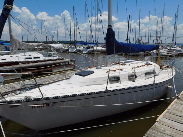 Slide: The Image of 1981 Pearson 32 sailboat docked at marina under blue sky. - 0