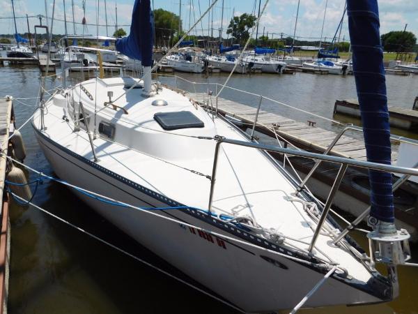 Slide: The Image of 1981 Pearson 32 sailboat docked at a marina, surrounded by other boats. - 7
