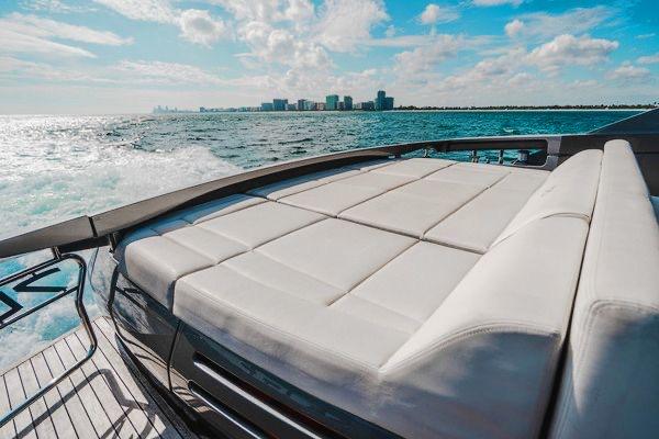 Slide: The Image of Luxurious 2015 Pershing 70 yacht with sunbed, cruising on open water under a bright sky. - 28