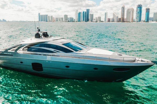 Slide: The Image of Luxury 2015 Pershing 70 yacht cruising near a city skyline on turquoise waters. - 3
