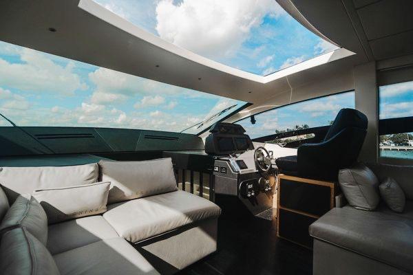 Slide: The Image of Luxurious interior of a 2015 Pershing 70 yacht with modern seating and panoramic windows. - 36