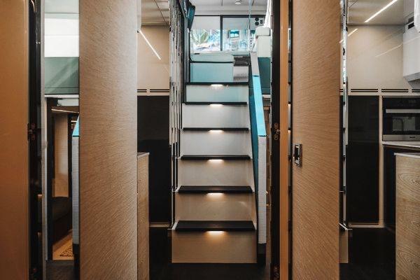 Slide: The Image of Interior of 2015 Pershing 70 yacht with modern staircase and sleek design elements. - 46