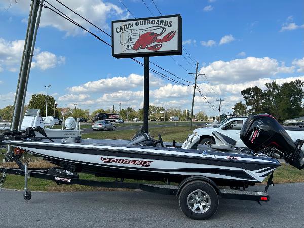 Slide: The Image of 2024 Phoenix 518 Pro boat at Cajun Outboards dealership. - 1