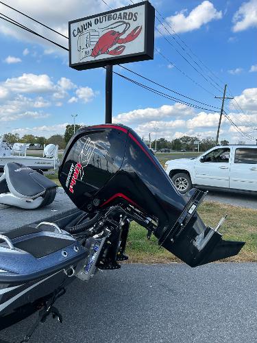 Slide: The Image of 2024 Phoenix 518 Pro boat with outboard motor at Cajun Outboards dealership. - 6