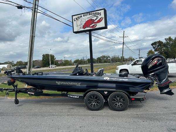 Slide: The Image of 2024 Phoenix 721 Pro XP bass boat at Cajun Outboards dealership. - 1