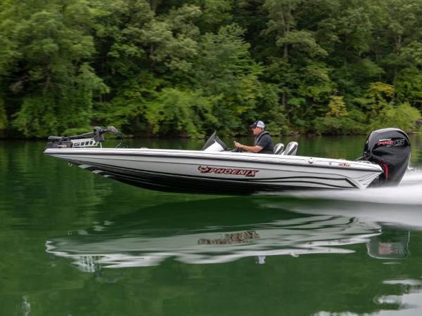 Slide: The Image of 2025 Phoenix 818 Pro boat speeding on a serene lake with lush green forest backdrop. - 1