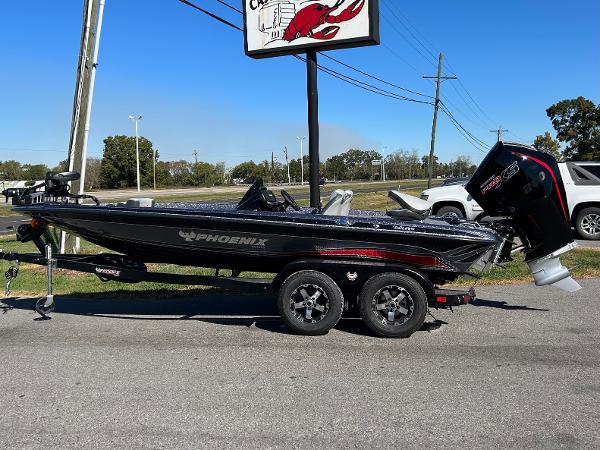 Slide: The Image of 2024 Phoenix 819 Pro bass boat on a trailer in a parking lot. - 1