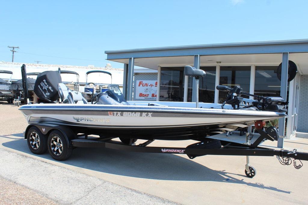 Slide: The Image of 2024 Phoenix 819 Pro boat on trailer outside dealership, showcasing sleek design and modern features. - 1