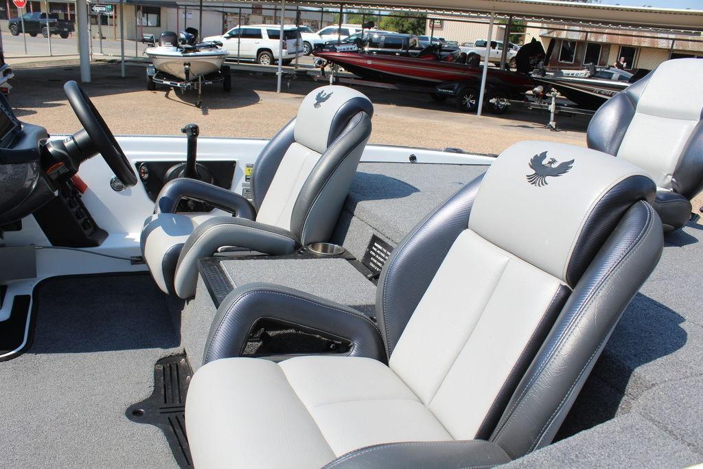 Slide: The Image of 2024 Phoenix 819 Pro boat interior with comfortable seating and steering console. - 12