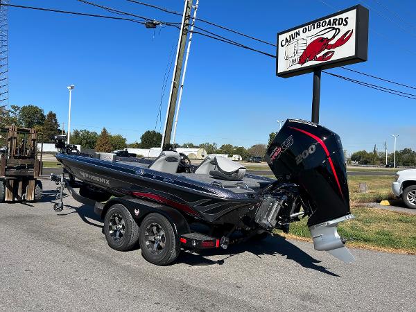 Slide: The Image of 2024 Phoenix 819 Pro boat at Cajun Outboards dealership. - 2