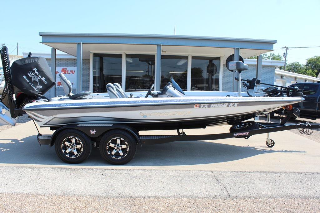 Slide: The Image of 2024 Phoenix 819 Pro boat on trailer, parked outside a dealership. - 2