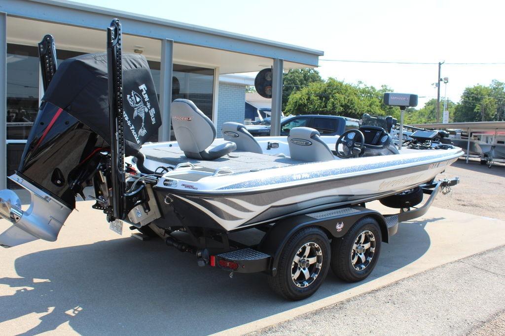 Slide: The Image of 2024 Phoenix 819 Pro boat on trailer, parked outside dealership. - 3