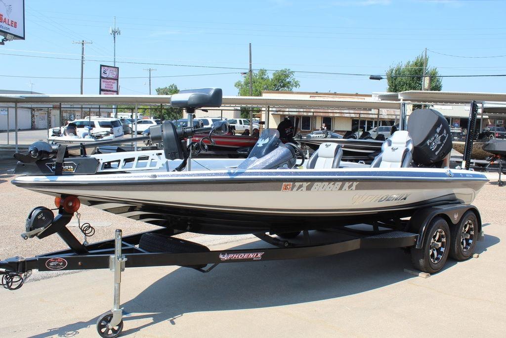Slide: The Image of 2024 Phoenix 819 Pro boat on trailer in outdoor dealership setting. - 4