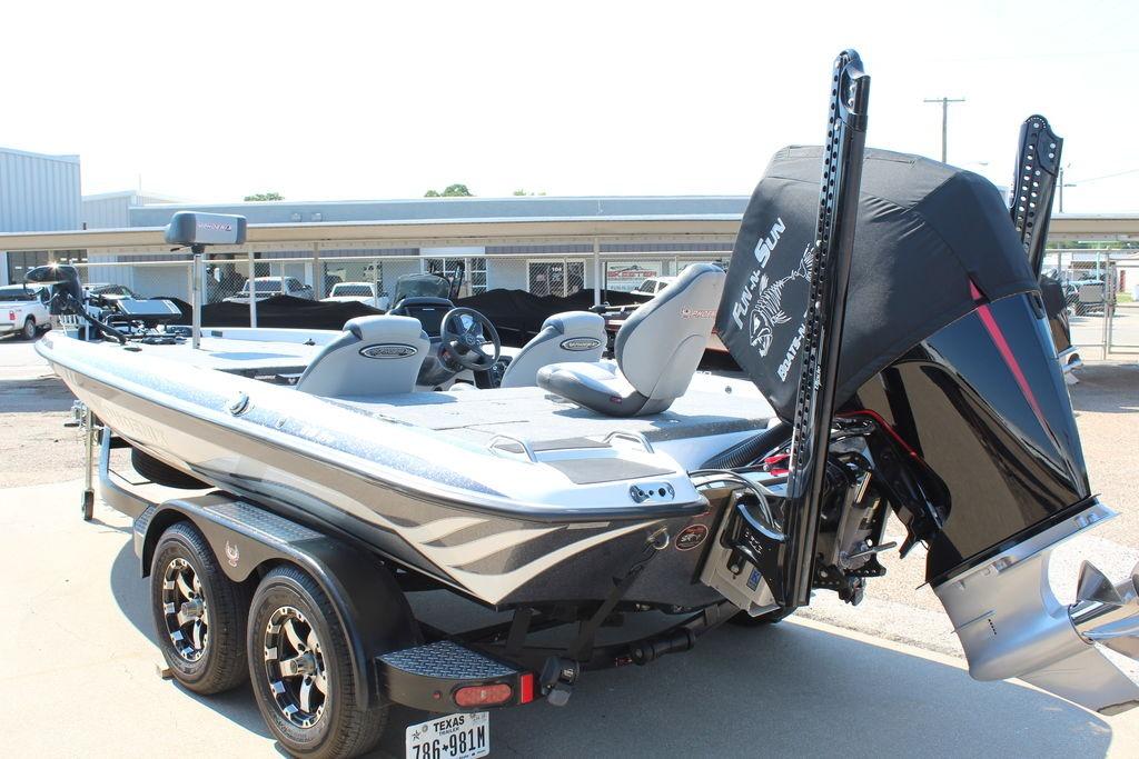 Slide: The Image of 2024 Phoenix 819 Pro boat with dual axle trailer, parked outdoors. - 5