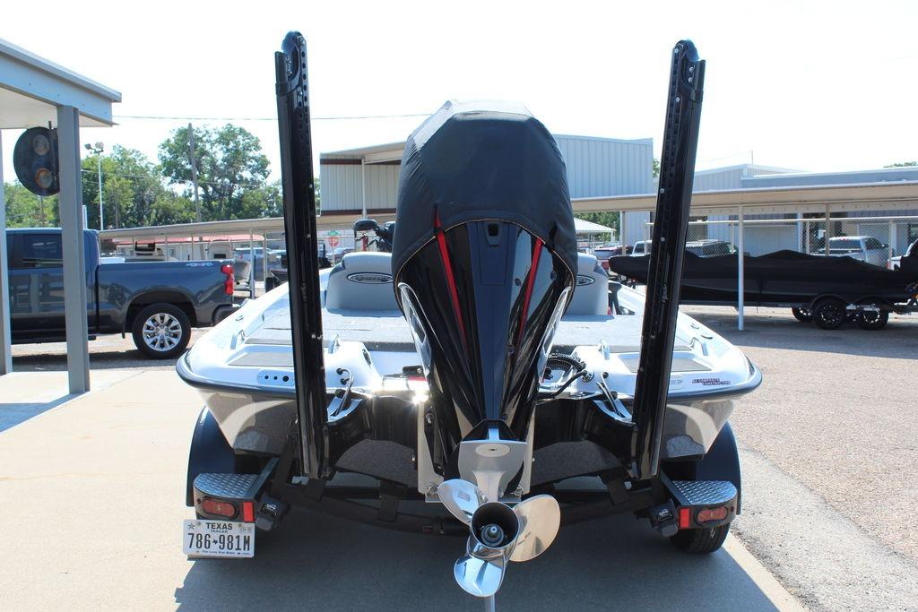 Slide: The Image of 2024 Phoenix 819 Pro boat rear view with motor and trailer in a parking lot. - 8