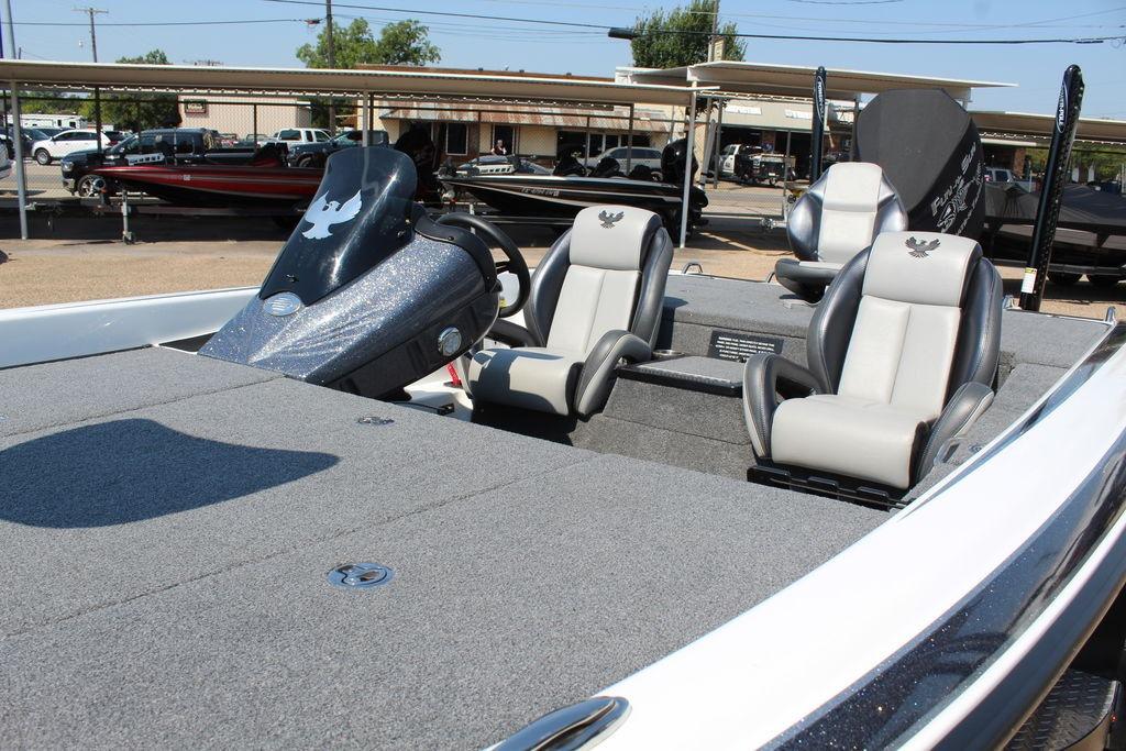Slide: The Image of 2024 Phoenix 819 Pro boat interior with dual seats and steering console. - 9