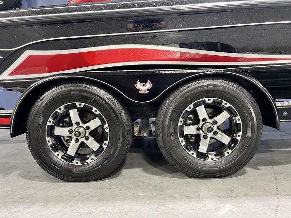 Slide: The Image of 2022 Phoenix 919 Pro XP trailer with dual wheels and sleek black and red design. - 2