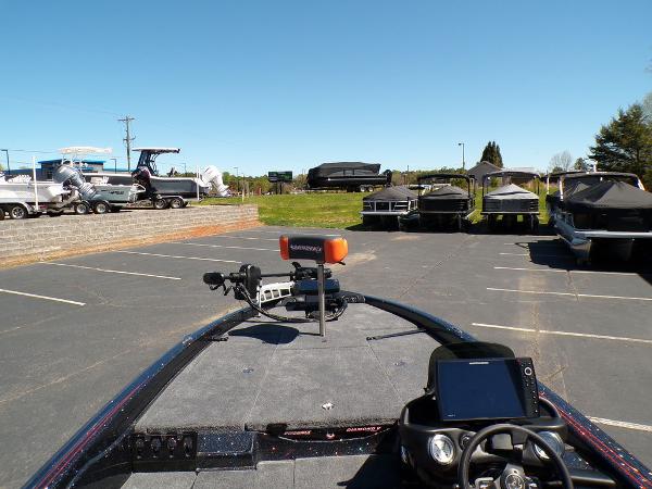 Slide: The Image of 2024 Phoenix 919 Pro XP boat in a parking lot with other boats. - 11