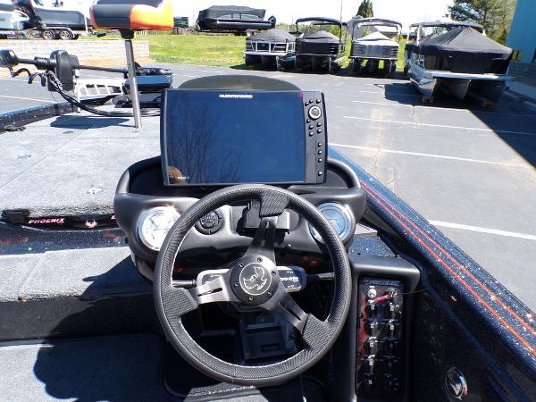 Slide: The Image of 2024 Phoenix 919 Pro XP boat dashboard with steering wheel and navigation system. - 14
