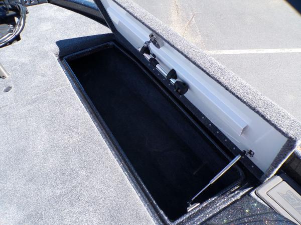 Slide: The Image of 2024 Phoenix 919 Pro XP boat storage compartment with open lid. - 17