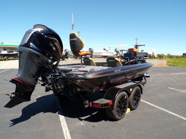 Slide: The Image of 2024 Phoenix 919 Pro XP boat with powerful outboard motor in parking lot. - 6