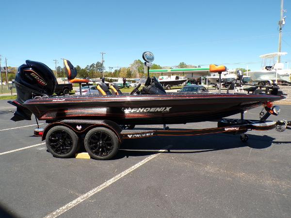 Slide: The Image of 2024 Phoenix 919 Pro XP boat on a trailer in a parking lot. - 7