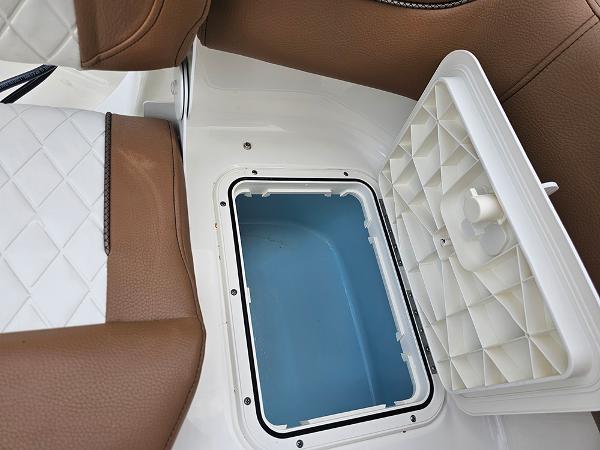 Slide: The Image of Open storage compartment on 2025 Pioneer 202 Islander boat with brown and white seating. - 11
