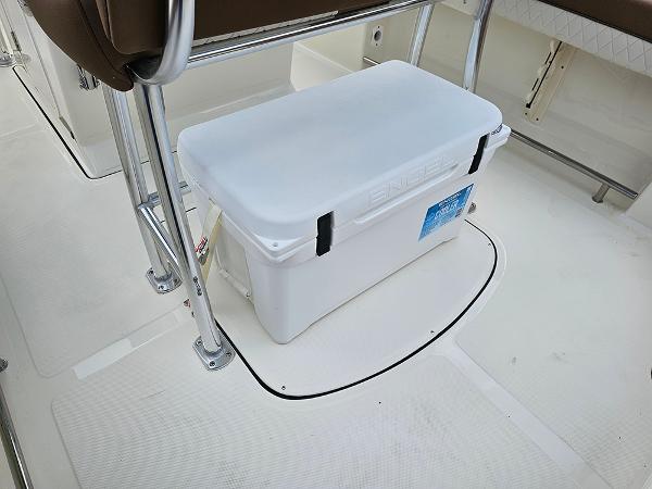 Slide: The Image of 2025 Pioneer 202 Islander boat interior with a white cooler under a seat. - 12